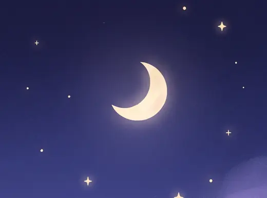 Una luna creciente sobre un cielo índigo lleno de estrellas